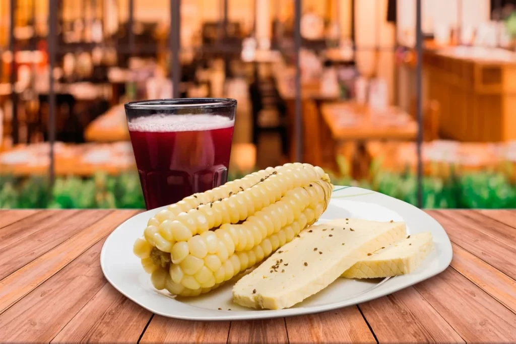 Traditional Peruvian choclo con queso served with a local drink — a simple and authentic taste often found among non touristy things to do in Peru.