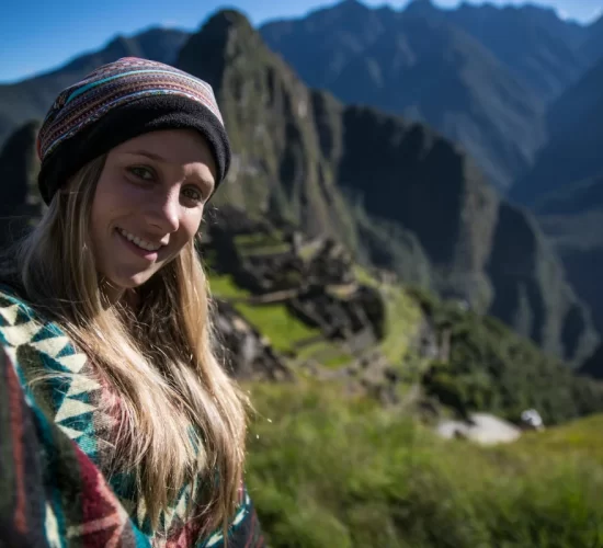 Woman taking a selfie at Machu Picchu during a romantic glamping in Peru for couples experience
