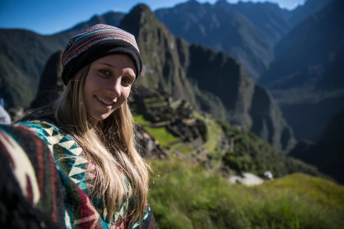 glamping in peru for couples machu picchu selfie Woman taking a selfie at Machu Picchu during a romantic glamping in Peru for couples experience