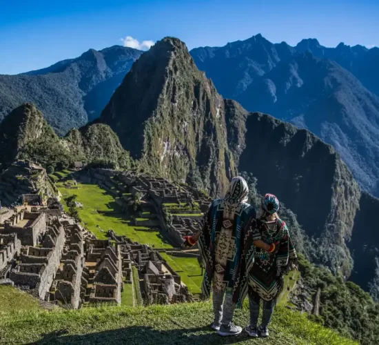 Couple on their honeymoon at Machu Picchu after completing the Inca Trail, surrounded by the Andes mountains
