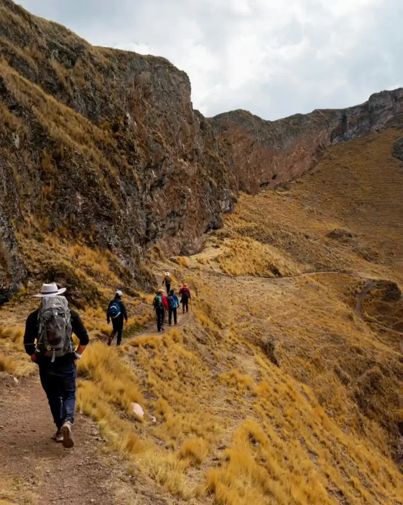 honeymoon on the inca trail hiking couples Couples enjoying their Honeymoon on the Inca Trail, hiking through scenic Andean landscapes surrounded by golden mountains.