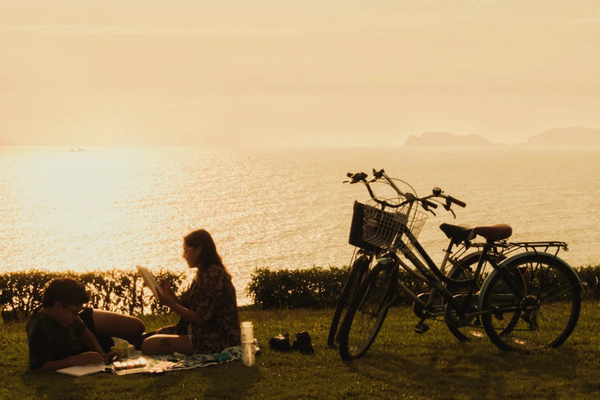 peru honeymoon lima coast couple sunset Couple reading together by the Lima coast during sunset, enjoying a romantic moment on their Peru honeymoon.