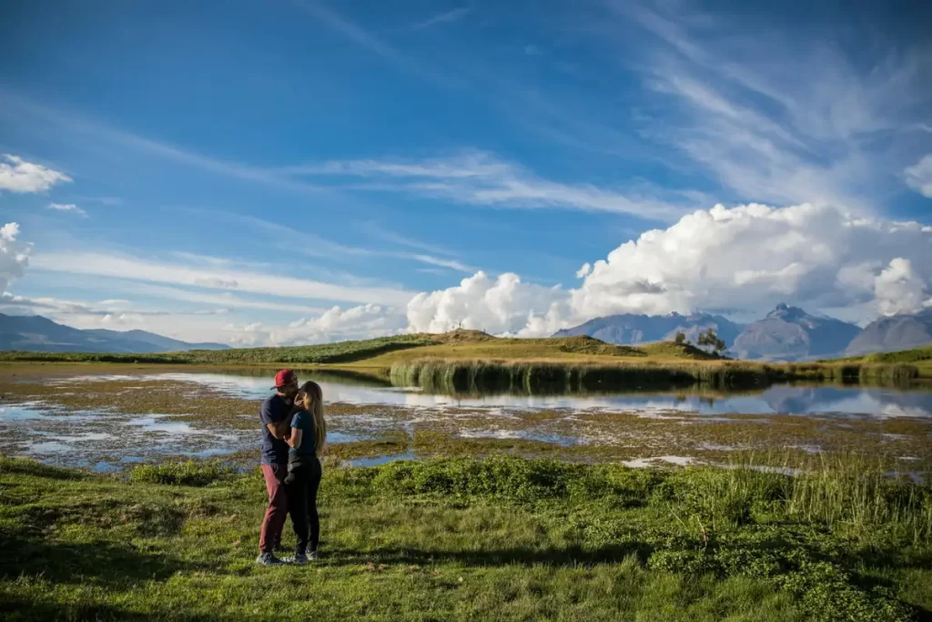 romantic couple northern peru mountain lake Couple embracing by a mountain lake in Northern Peru surrounded by nature