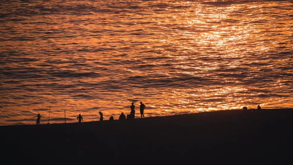 Sunset at Punta Hermosa beach in Lima with locals enjoying the coast, highlighting non touristy things to do in Peru