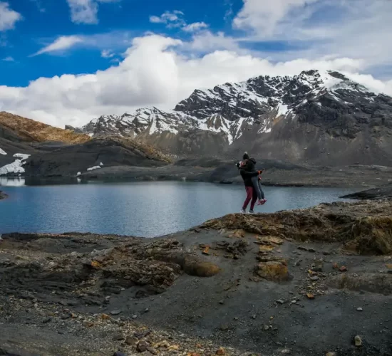 Couple embracing at a scenic Andean lake during their romantic getaway in Peru