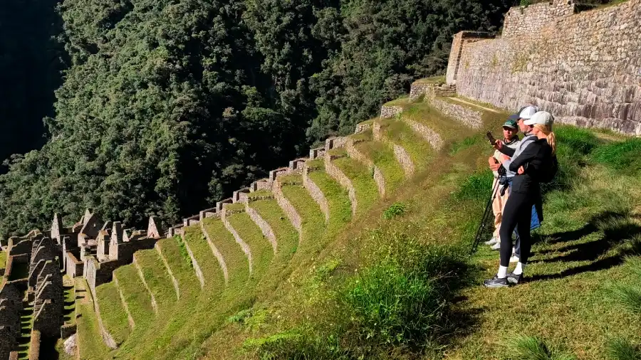 Couple exploring Inca terraces with their guide during their luxury glamping Inca Trail honeymoon