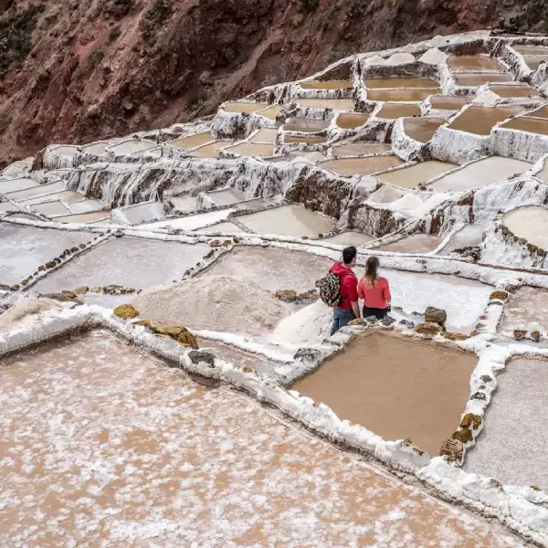 Couple exploring the Maras salt mines during their Luxury Peru Highlights Honeymoon.
