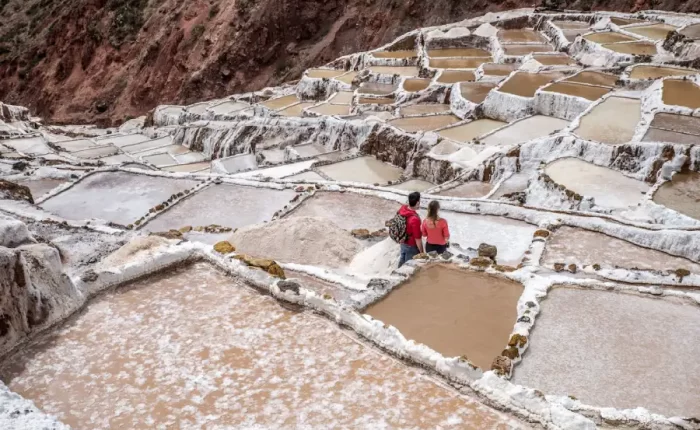 Couple exploring the Maras salt mines during their Luxury Peru Highlights Honeymoon.
