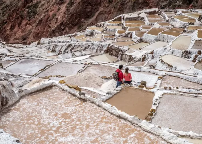 Couple exploring the Maras salt mines during their Luxury Peru Highlights Honeymoon.