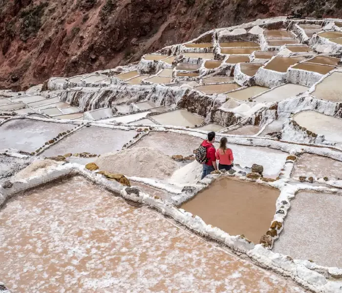 Couple exploring the Maras salt mines during their Luxury Peru Highlights Honeymoon.